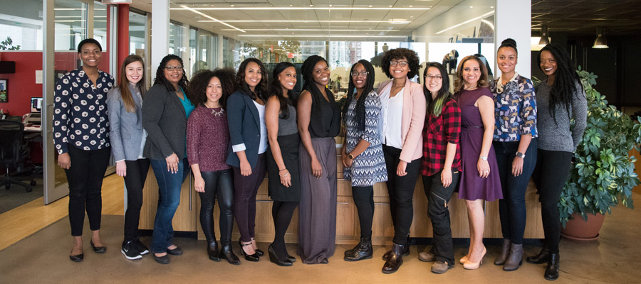 Group of women involved in Workplace Campaign for United Way of York County, SC posing together and smiling in an office.