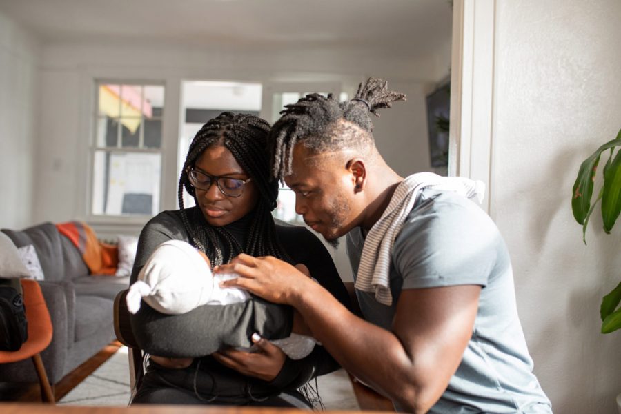 Young couple admiring their new baby together.