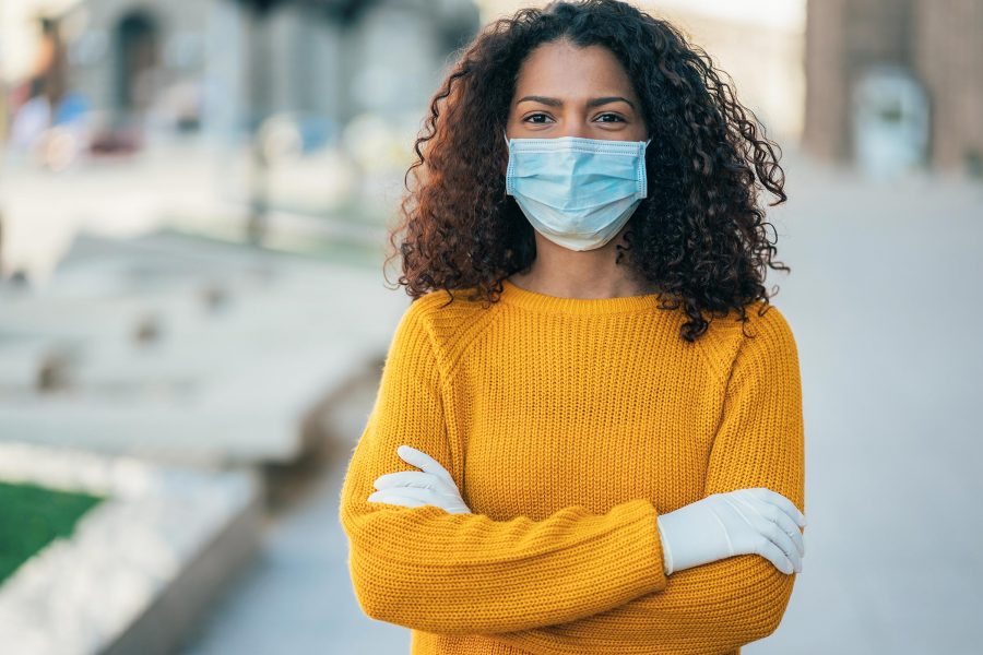 Young women wearing gloves and face mask to protect herself from the Coronavirus.